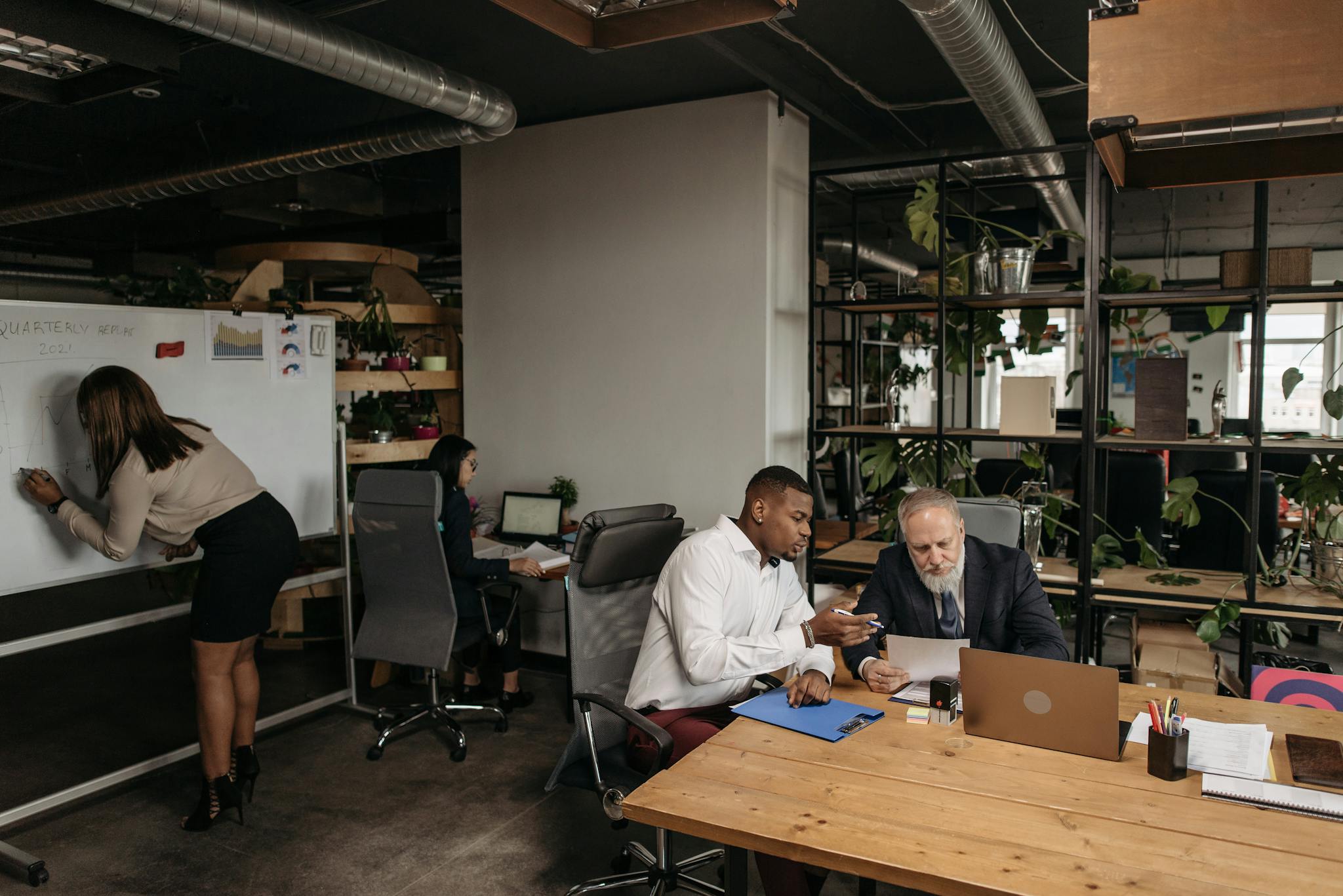Diverse team collaborating in a modern office environment, planning strategy.
